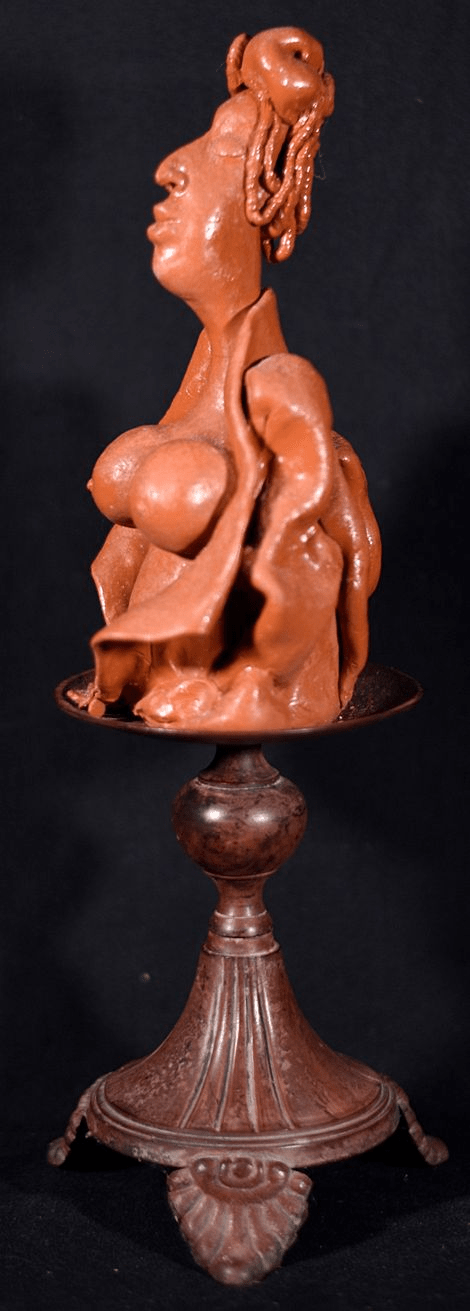 Bare breasted womanwith coiled hair  in orange.  Polymer Clay Sculpture 14 x 4.5 x 4 by artist Hollis Richardson