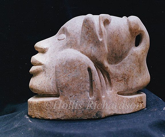 Sculpture of head in rose colored alabaster stone in repose. Smooth rounding shapes invites touch, by artist Hollis Richardson